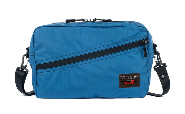 A Packing Cube Shoulder Bag in Cobalt (blue with light blue grid) 210 Cerylon with a shoulder strap